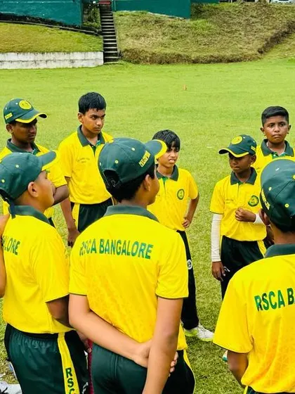 A coach gives a team talk to the U-16 squad during their tour of Sri Lanka, adapting strategies to foreign conditions.