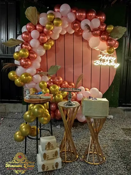 A purple and white balloon ring setup for an intimate home birthday celebration.