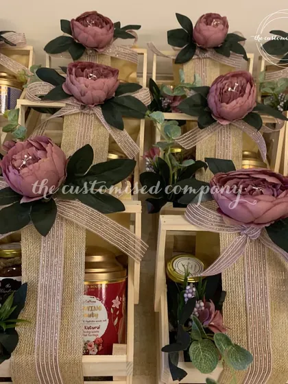 This image captures the rustic elegance of my wooden crate hampers for Diwali. I love combining natural textures with beautiful floral arrangements and premium goodies to create a truly sophisticated gift.