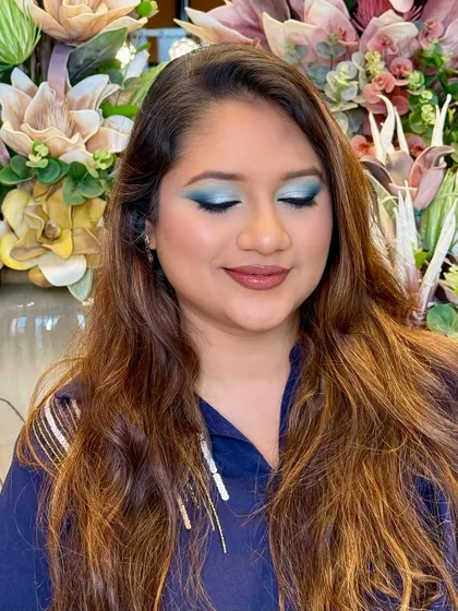 With eyes closed, you can see the full artistry of this blended teal eyeshadow. This shot showcases the smooth gradient of color, a key technique I teach for creating professional-looking eye makeup.