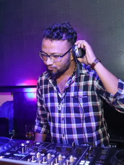 Adjusting my headphones to get the perfect sound balance. This is a classic DJ pose that shows my dedication to audio quality.