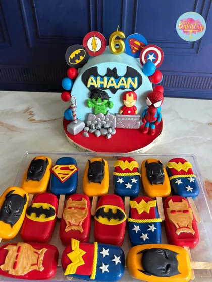 For Ahaan's 6th birthday, we assembled the ultimate superhero team. This cake features iconic heroes like Hulk, Iron Man, and Spider-Man, complete with their symbols and Thor's hammer, paired with matching superhero-themed cakesicles.