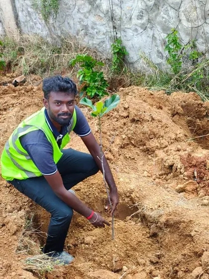 The same image of our team member planting a young tree, a fundamental part of our mission to enhance green cover in Bangalore.