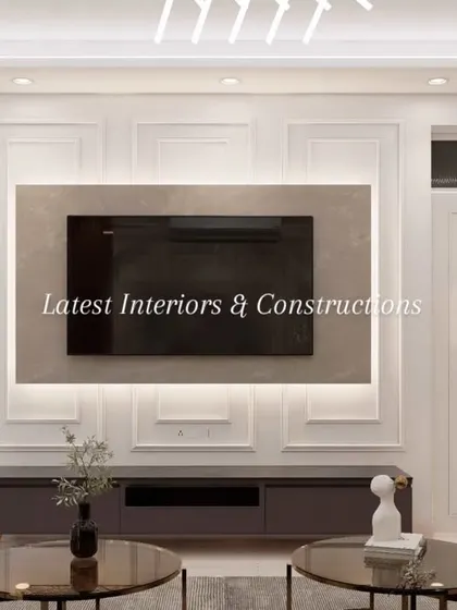 The television unit is designed with classic wall molding and subtle backlighting, creating an elegant feature that feels integrated into the room's architecture. The design ensures that technology does not overpower the room's sophisticated feel.