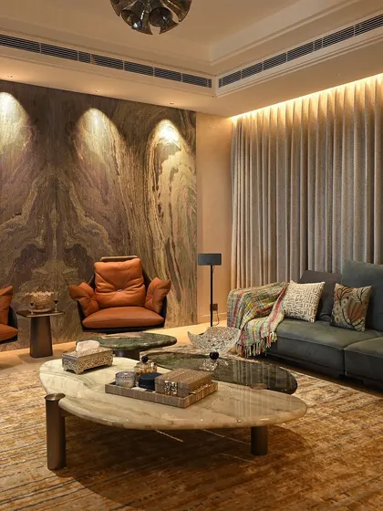 Here, accent lighting is used to draw attention to the stunning marble wall. This technique adds texture and drama to the living space, all controlled with a simple tap.