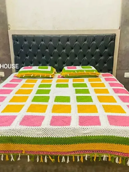 A full view of the vibrant bedspread, showcasing the detailed tassel work along the edges. I can add custom borders like tassels or lace to any blanket or throw.