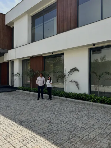 Our co-founders in front of the House of Passages. The project's facade, with its clean white planes and warm wood panels, provides a perfect backdrop that reflects our studio's contemporary aesthetic.