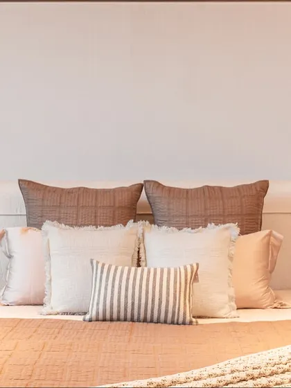 The full view of the custom headboard, which features a combination of fabric panels and metal inlays. The design adds a subtle architectural element to the room.