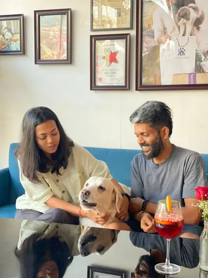 A moment of shared affection between a family and their gentle Labrador. It's these quiet, loving interactions that fill our café with warmth.