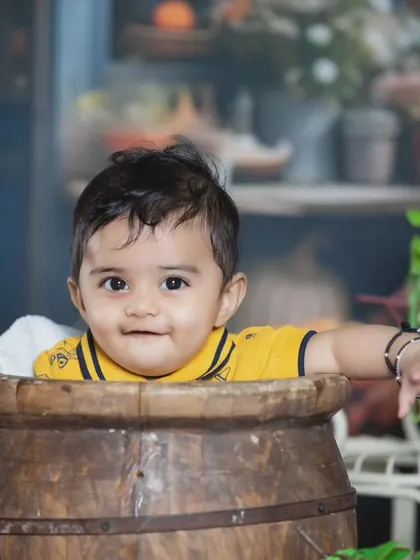 A sweet smile from the baby in the barrel.