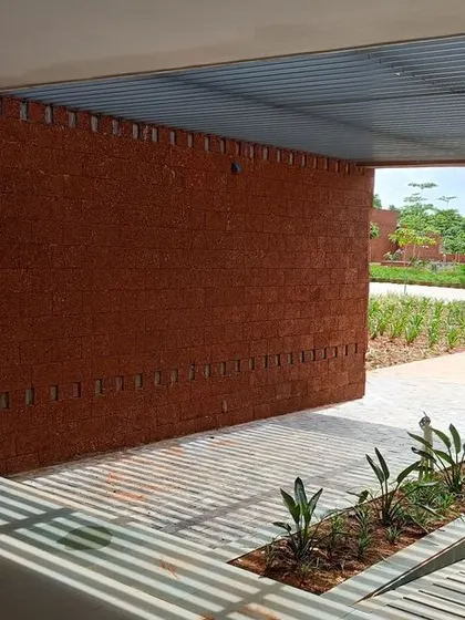 The play of light and shadow on the steps and laterite walls at the Bagchi Karunashraya hospice. The use of local materials and open-to-sky spaces connects the building to its environment.