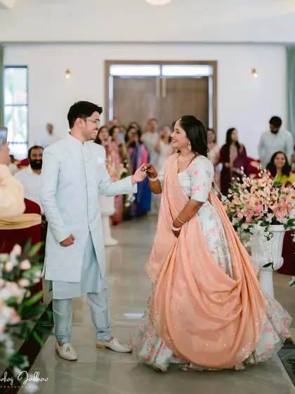 The couple's entrance into their engagement ceremony, filled with anticipation and smiles.