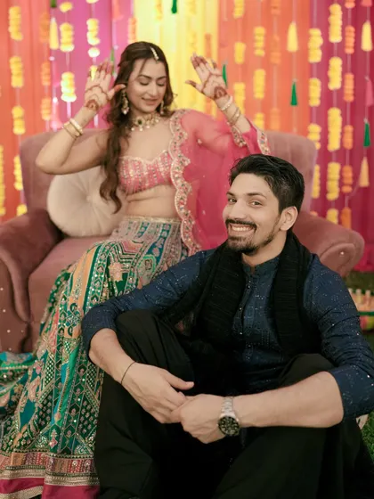 A fun and candid shot of the couple, capturing their playful dynamic during the Sangeet.
