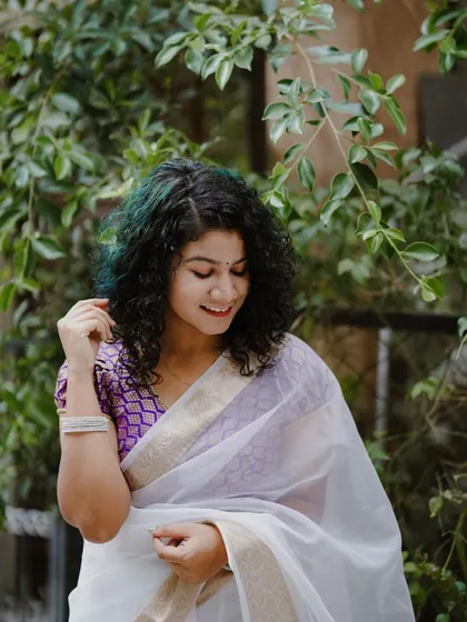 A joyful and candid shot from the Onam series. Her bright smile and relaxed posture capture the happy and celebratory spirit of the festival.