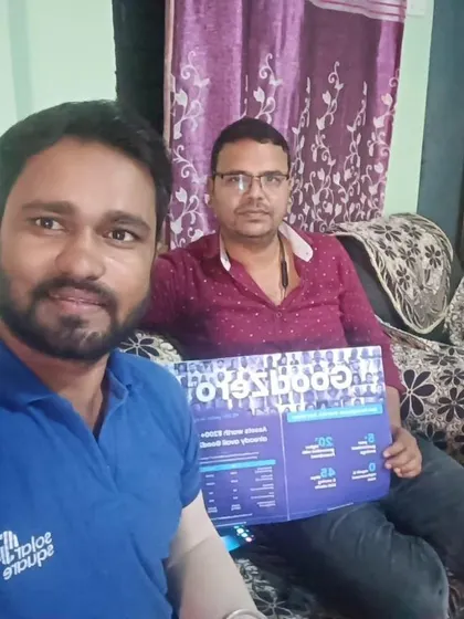 Our team member takes a selfie with a customer holding our "GoodZero" brochure.