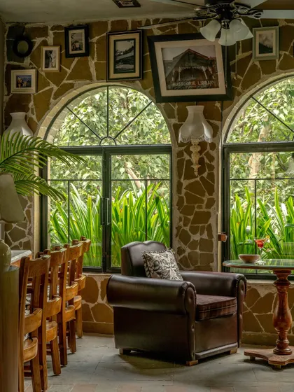 For Echoes Café, we transformed a challenging layout into a series of intimate, soulful corners. This nook, with its rubble-clad walls, arched window, and plush armchair, feels collected over time. It is a space designed not just for a meal, but for a moment of quiet reflection.