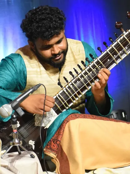 Another angle from the same performance, showing the microphone setup used to capture the delicate sounds of the sitar and tabla for the audience.