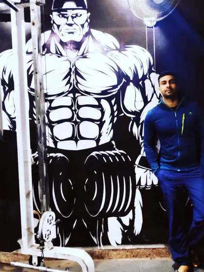 Standing in front of our motivational wall art. The energy at Loordz Gym is all about inspiring you to push your limits.