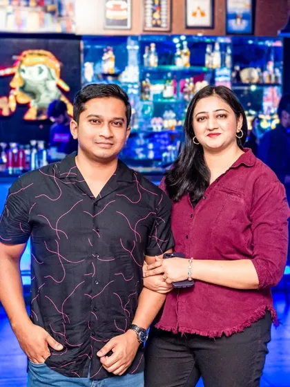 Posing for a photo in front of the bar. The blue lighting and extensive drink selection make for a great backdrop.