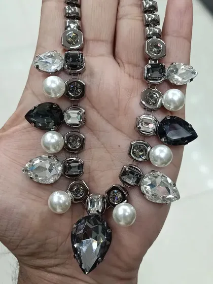 This is a modern, western-style necklace made with grey and clear crystals and pearls. It's a unique piece that is perfect for formal parties or when you want a stylish, non-traditional look.