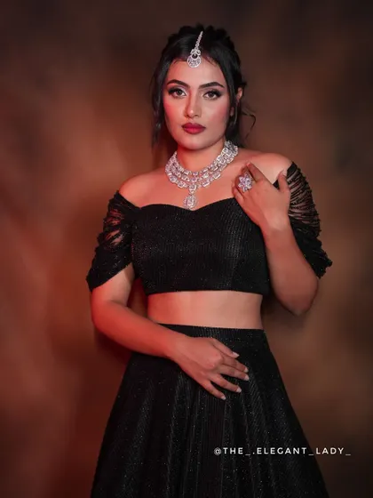 A classic portrait in the black shimmer lehenga, paired with a stunning diamond necklace. This is the epitome of modern party wear elegance.