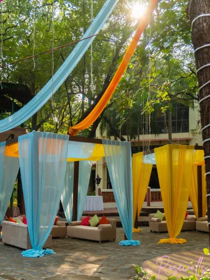 I created cozy cabana-style seating areas using sheer drapes in yellow and blue, offering guests a comfortable and semi-private space to relax.