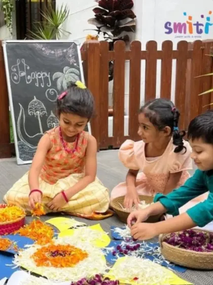 Children work together on the ground to create a large, beautiful Pookalam for Onam. This collaborative art project teaches teamwork and appreciation for traditional art forms.