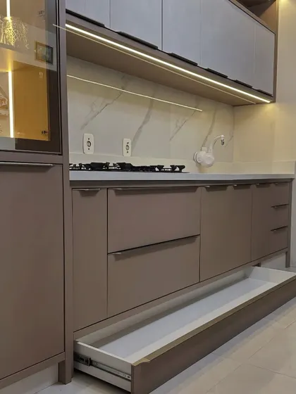 This wide, deep drawer is part of a modern kitchen setup, providing ample space for large utensils or stacks of plates. The sleek design is complemented by a durable, easy-to-clean interior.