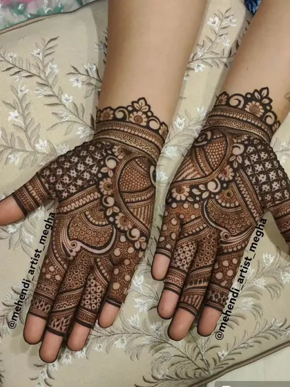 An intricate and delicate design for the back of the hands, featuring a mix of paisley, floral, and geometric elements that flow together beautifully.