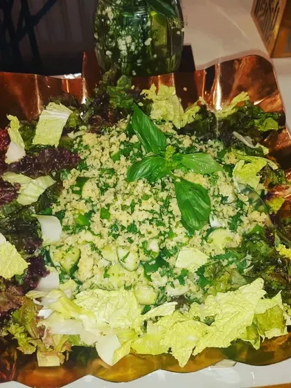 A healthy tabbouleh salad with fresh basil, served in a stylish copper bowl for a modern touch.
