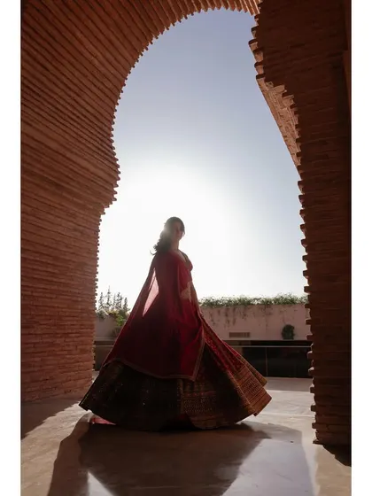 A silhouette of the bride, Samriddhi, against the sun in a beautiful brick archway in Morocco. The light, shadow, and architecture come together to create a powerful and artistic portrait.