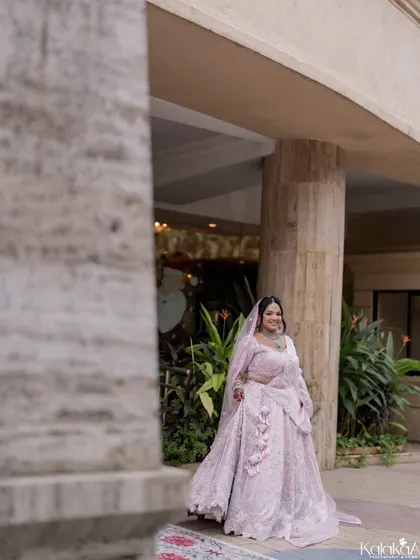 A candid shot of the bride walking, her beautiful lehenga flowing around her.