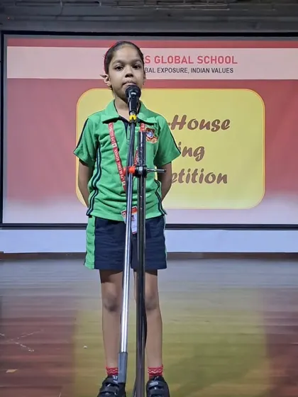 Another young participant takes the stage at the Inter-House Singing Competition. The event celebrates the spirit of Teacher's Day through the universal language of music.