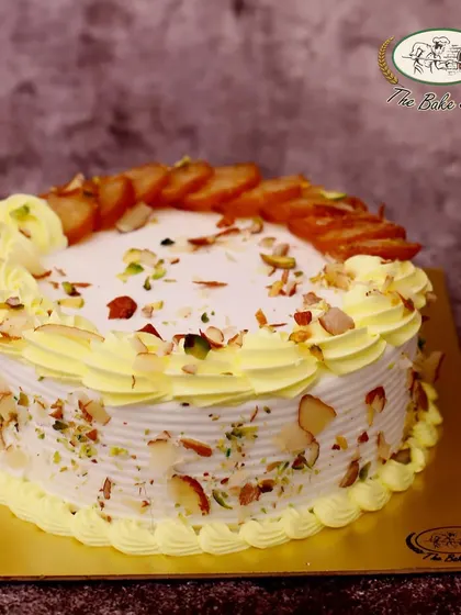 Another beautiful presentation of our Gulab Jamun Cake, garnished with nuts and ready to be the star of your celebration.