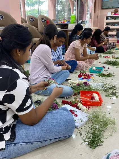 A group of students engrossed in creating their floral masterpieces.
