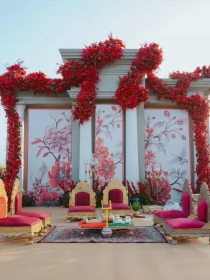 For this 'Gulal Bagh' themed wedding, the decor was set in auspicious red and white. The grand seating structure, adorned with cascading red florals, created a royal courtyard ambiance for the final knot.