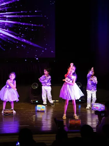 Our little stars in purple costumes, striking a pose during their energetic and cute performance.