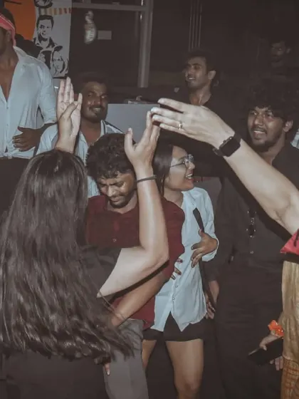 A group of friends dancing with their hands up, completely into the music. This is what a great night looks like.