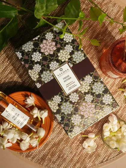 The beautiful packaging for our Fresh Mogra reed diffuser. The intricate floral design on the box is a preview of the exquisite fragrance contained within.
