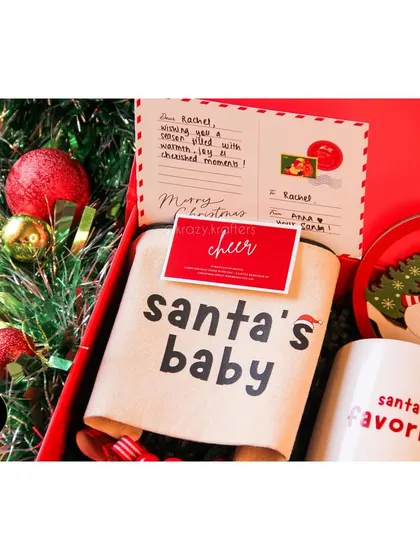 A 'Santa's Baby' pouch, perfect for holding small essentials, featured in our 'Holiday Home' hamper.