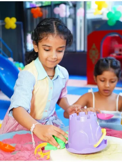 Building and creating in the sensory sand pit. This activity is perfect for tactile exploration and imaginative play, allowing kids to construct their own little worlds.