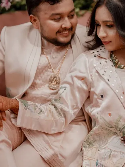 A tender moment between the couple, with their hands intertwined, showcasing their connection.