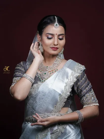 A model poses elegantly during a studio shoot, demonstrating a bridal makeup look. My photography aims to highlight the skill of the makeup artist and the beauty of the model.