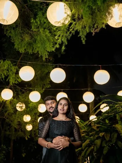 A couple embraces under a canopy of glowing paper lanterns. This night shot is full of warmth, romance, and a touch of whimsy.