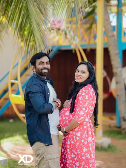 A happy and casual couple's portrait in a colorful outdoor setting.
