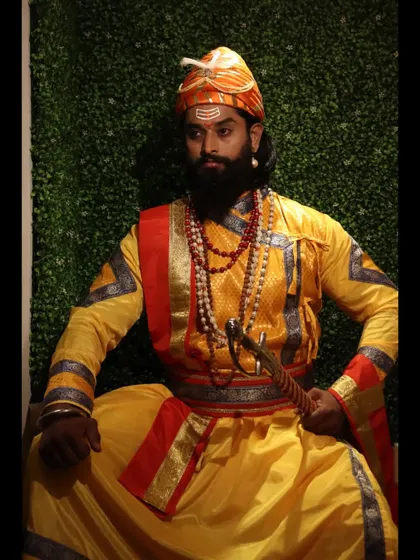 A formal, seated portrait against a simple green backdrop. This classic pose conveys authority and dignity, fitting for the historical character being portrayed.