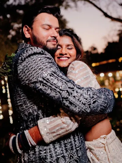 A warm, affectionate hug between the couple during their Sangeet night, capturing the love and emotion of the celebration.