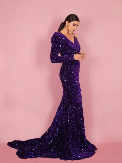 A side-profile shot of Daisy Shah, highlighting the elegant silhouette of the gown and creating a sophisticated, editorial feel.