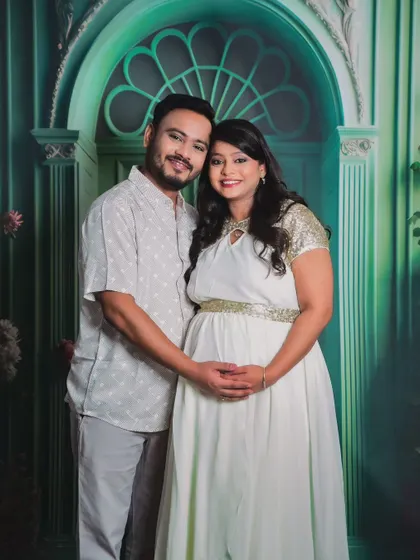 A lovely couple portrait taken against a painted floral backdrop in the studio, creating a classic and artistic feel.