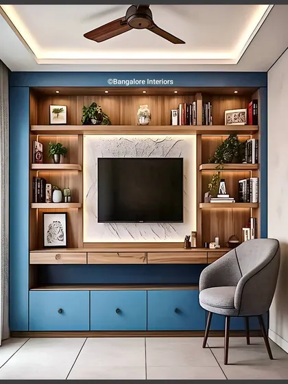 I used a bold blue for the lower cabinets to add a pop of color to this living room. The TV is set against a backlit marble-effect panel, framed by wooden shelves that provide balanced, symmetrical storage.